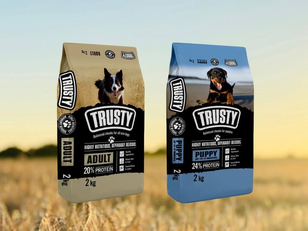 Two bags of Trusty puppy and adult dog food side by side, showing the transition from puppy food to adult food.